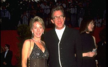 Laura Deibel and Tim Allen pose for a picture at an award ceremony. 